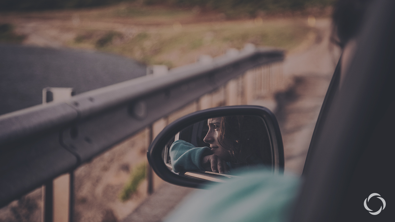 a woman looking out a car window