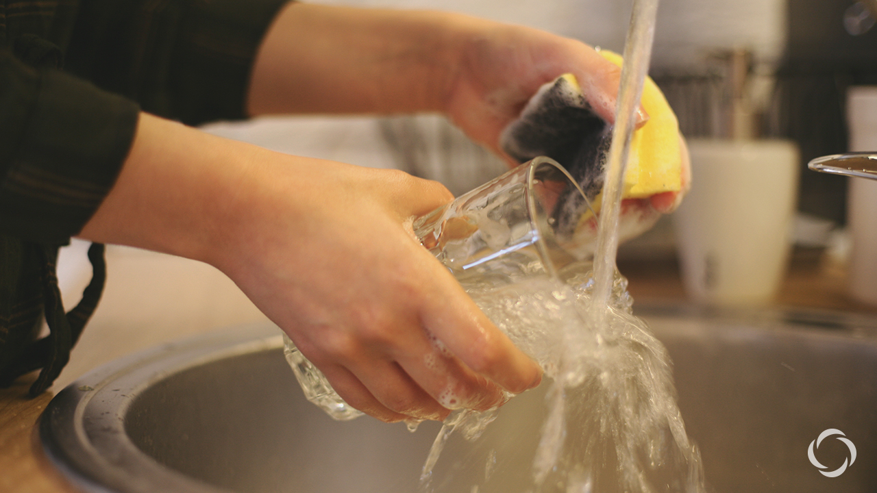 a person washing a cup