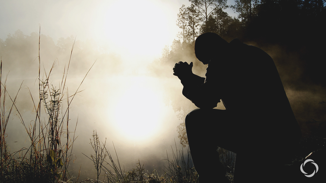 praying man at dusk