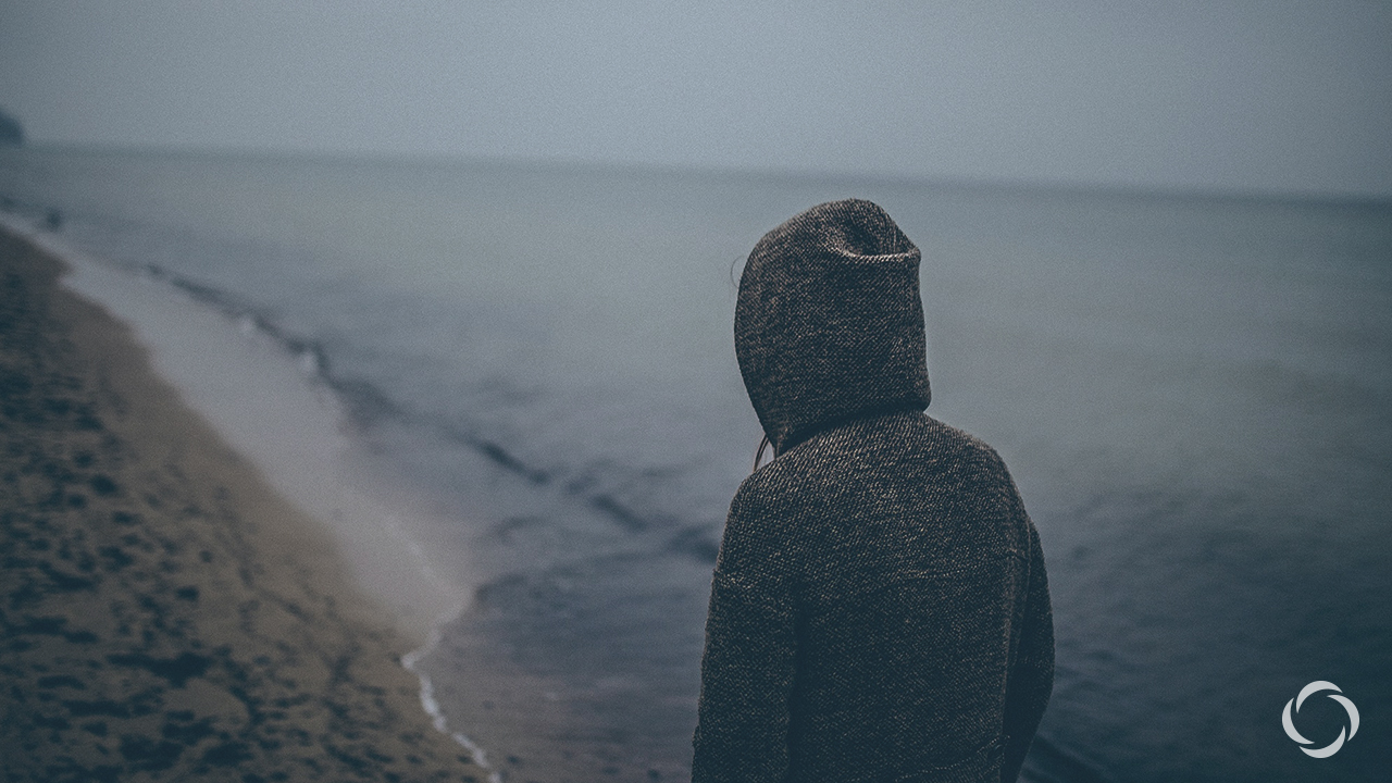 Woman with a hoody at the beach
