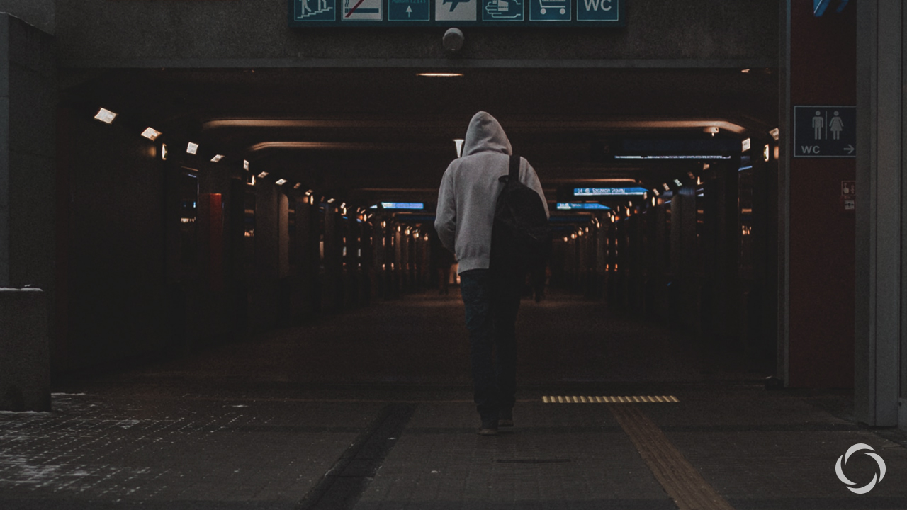 A man walking through a subway tunnel