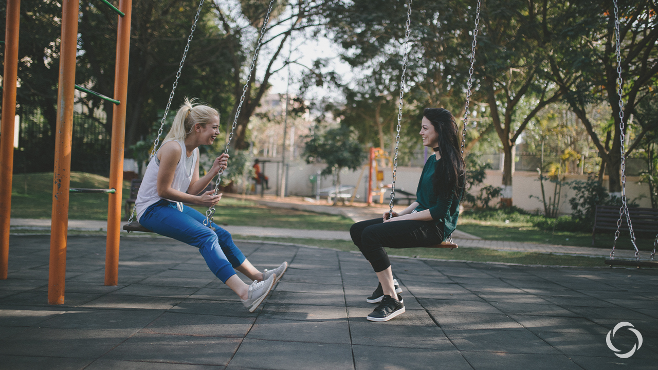 two girls on a swing set