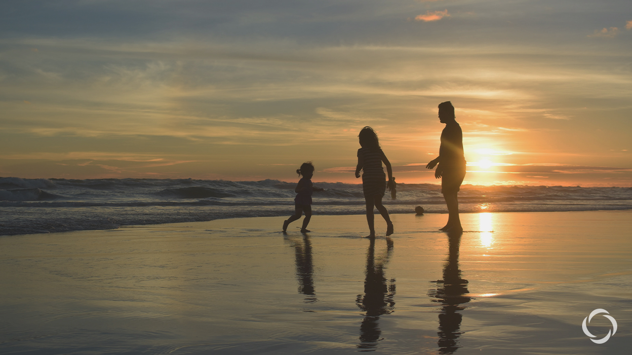 A family at the beach during sunset